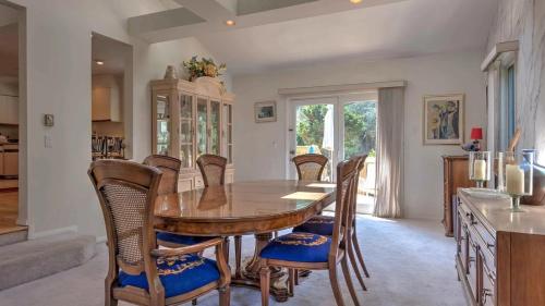 a kitchen and dining room with a wooden table and chairs at Villa Lalam in Southampton