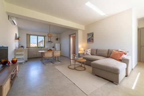 a living room with a couch and a table at Kallisti Stay in Artemida