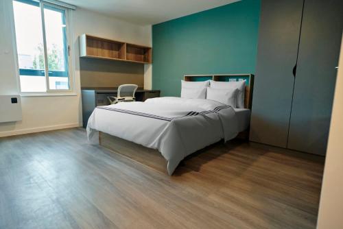 a bedroom with a large white bed and a desk at Studios and Private Bedrooms with Shared Kitchen at Canvas Bristol near the City Centre in Bristol