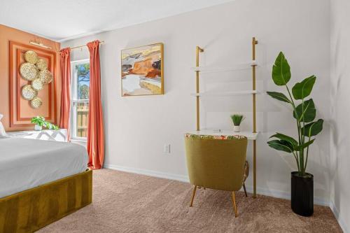 a bedroom with a bed and a desk and a plant at Brand New Theme House w Game Room - Encanta Magical in Palm Bay