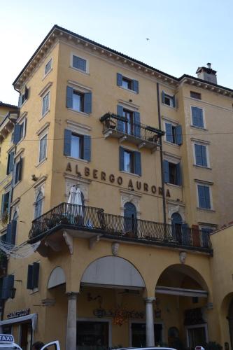 a building with a sign on the side of it at Hotel Aurora in Verona