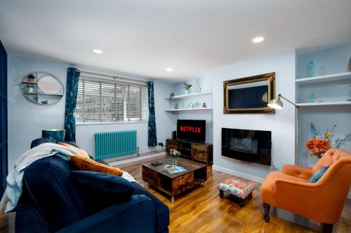 a living room with a couch and a tv at The Blue Barbican Flat- spacious, stylish, in a perfect location and accessible in Plymouth