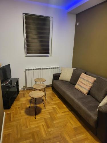 a living room with a couch and a table at E&M apartment in Zemun