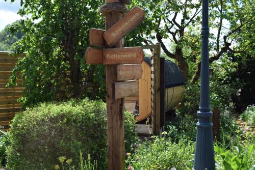 a wooden sign with street names on it next to a light pole at Ferienwohnung Baumkrone in Waldeck