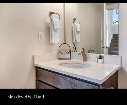 a bathroom with a sink and a mirror at Wasatch Springs 13804 by Moose Management in Park City