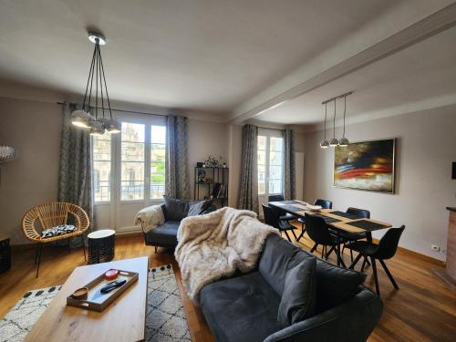 un salon avec un canapé et une table dans l'établissement Perle rare - Triangle d'or -98m2 - 6 pers, à Caen