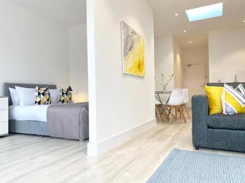 a bedroom with a bed and a couch and a chair at Cloud at Fleet Heights Apartment Two in Fleet