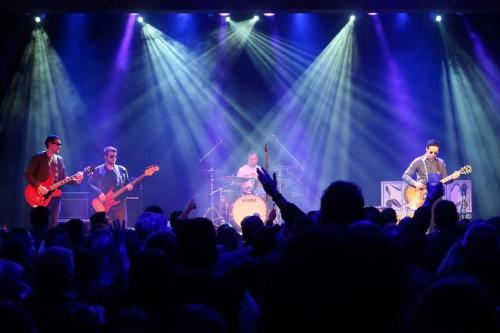 a group of musicians on a stage in front of a crowd at Cloud at Fleet Heights Apartment Two in Fleet