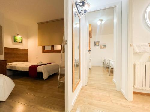 a room with a bed and a room with a mirror at Barthe Holidays I Apartamento amplio en Andorra 6PAX I Céntrico y luminoso I Central Park in Escaldes-Engordany