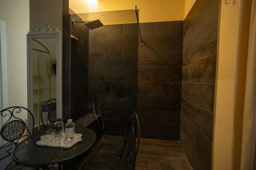 a bathroom with a shower with a table and a shower at DOMUS DEORUM in Naples