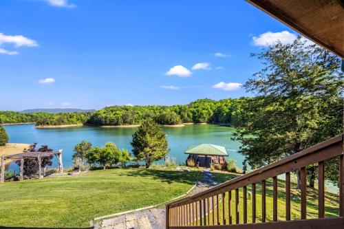 a view of a lake with a gazebo at Lakefront Retreat With Mountain Views, Private Boat Launch And Dock in Sevierville
