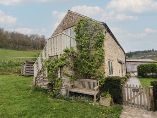 a stone house with a bench in front of it at The Burrows in York