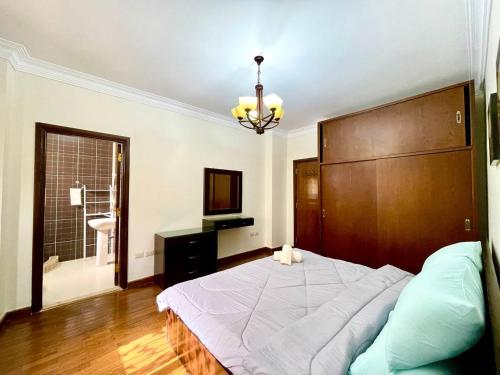 a bedroom with a large bed and a bathroom at 3Bedroom next to Downtown Mall New Cairo in Cairo