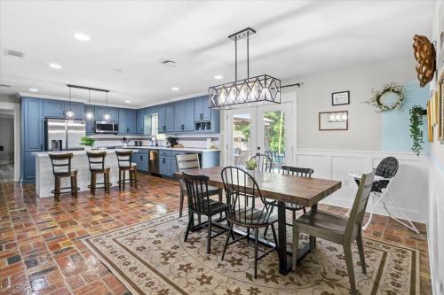 a kitchen and dining room with a table and chairs at Ranch Home Gem 5BR Home Sleeps 12 with Game Room in Gulfport