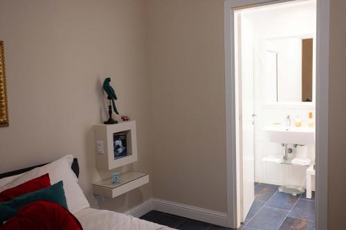 a bedroom with a bed and a bathroom with a window at DOMUS DEORUM in Naples