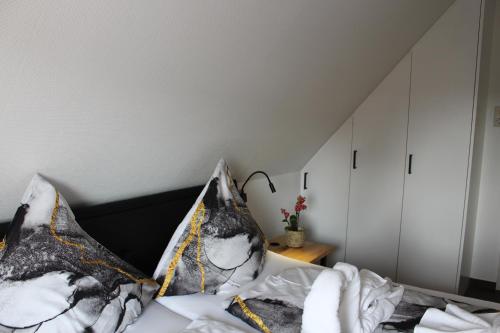 a bedroom with a bed with two pillows at Haus Deutsche Bucht in Borkum