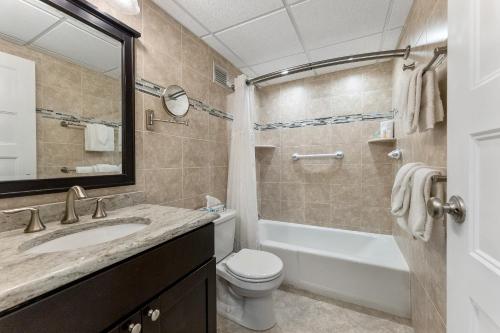 a bathroom with a sink and a toilet and a tub at Beachcomber Resort in Avalon