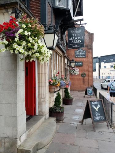 a building with flowers on the side of it at Masons Arms in York