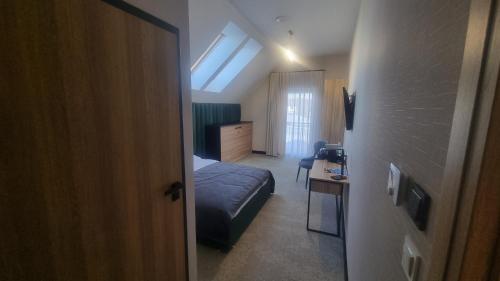 a bedroom with a bed and a room with a window at Piotruś Pan in Brzesko
