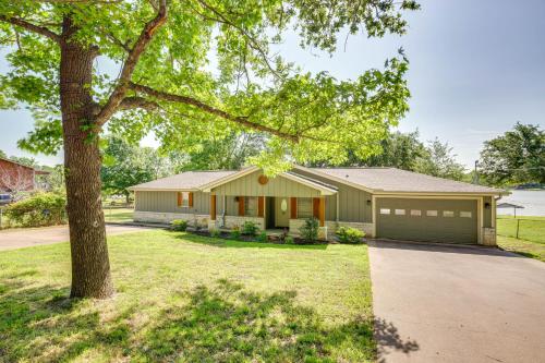 a house with a tree in front of it at Private Dock and Fire Pit Cedar Creek Reservoir Gem in Gun Barrel City