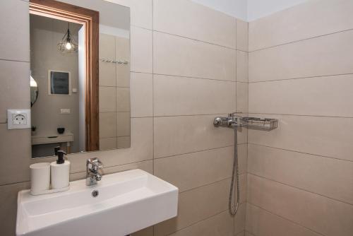 a white bathroom with a sink and a shower at 5 Keys in Zakynthos Town