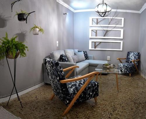 a living room with a couch and two chairs and a table at Meteora Mosaico House in Kastrákion