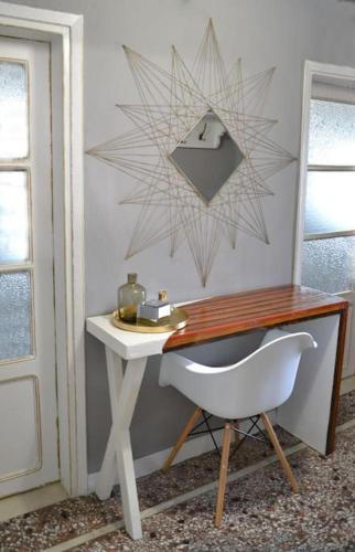 a desk with a white chair next to a door at Meteora Mosaico House in Kastrákion