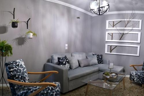 a living room with a couch and a table at Meteora Mosaico House in Kastrákion