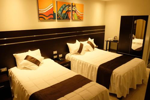 Cama o camas de una habitación en Hotel Puma'r Tacna