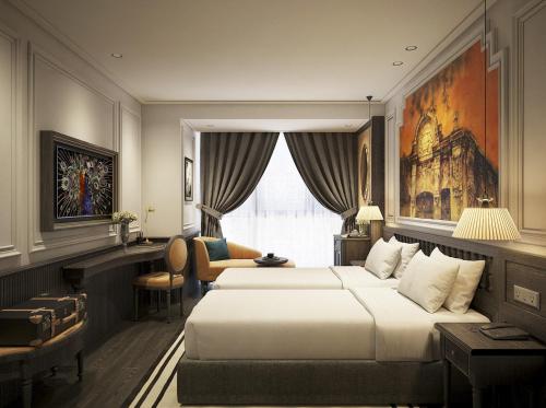 a hotel room with two beds and a desk at Luxe Paradise Premium Hotel in Hanoi