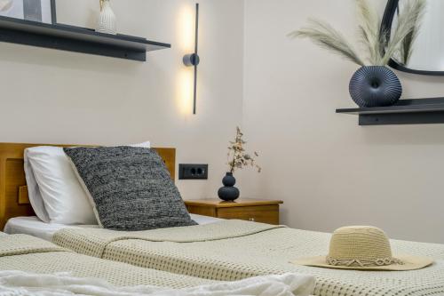 a bedroom with a bed with a hat on it at Rivulet Apartments in Laganas