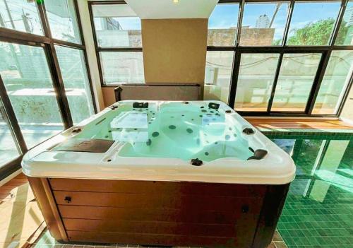a jacuzzi tub in a room with windows at Michelangelo 806 in Punta del Este