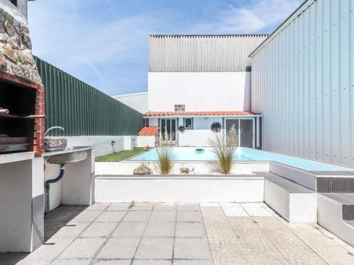 a courtyard with a swimming pool and a building at Vita Portucale ! Charneca Caparica Pool in Charneca
