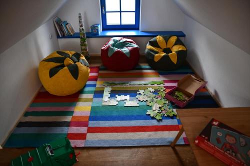 an attic room with a colorful rug with pumpkins on the floor at Tri borovice in Liptovský Mikuláš