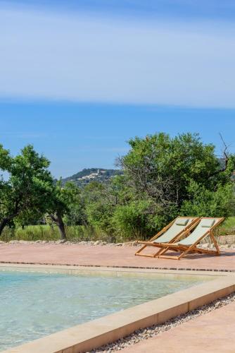 a hammock sitting next to a swimming pool at Agroturisme Subies in Selva
