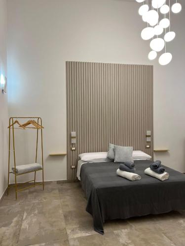 a bedroom with a bed with two towels on it at Rosina Apartament il corso in Torre del Greco