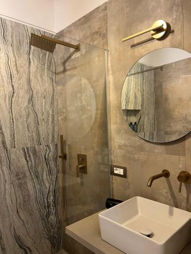 a bathroom with a sink and a mirror at Rosina Apartament il corso in Torre del Greco