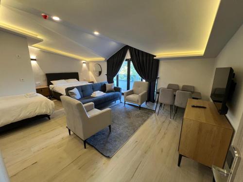 a large hotel room with a bed and a couch at Jest Hotel in Kemer
