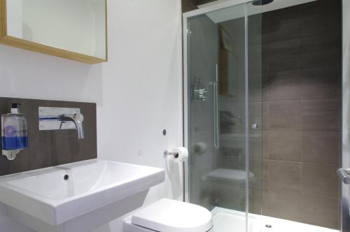 a bathroom with a toilet and a sink and a shower at Clerkenwell Premium Deluxe in London