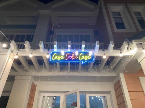 a neon sign on the front of a house at Holiday Villa Novaworld Phan Thiet in Phan Thiet