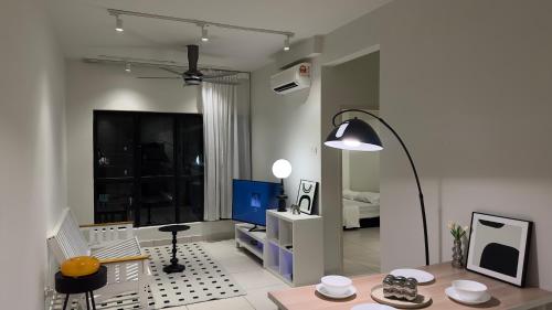 a living room with a table and a lamp at MRT asthetic condo in Kuala Lumpur