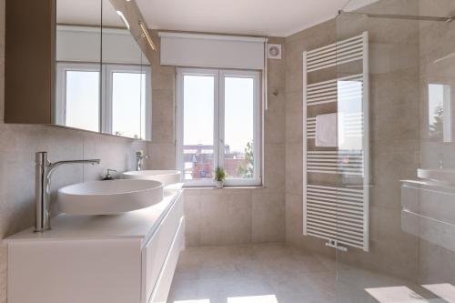 a bathroom with a sink and a mirror at Pins Dorés - A Luxurious and beautifully decorated villa with terrace and parking near the beach in Knokke-Heist