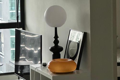a table with a mirror and a lamp on it at MRT asthetic condo in Kuala Lumpur