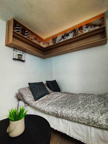 a bedroom with two beds and a table in it at Apartman Monroe in Sarajevo