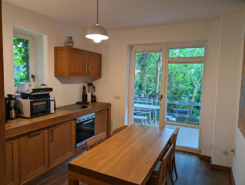 a kitchen with a wooden table and a dining room at Gruppenhaus Darmstadt in Darmstadt