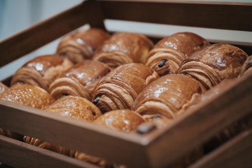a box full of donuts in a bakery at Hôtel Henry II Beaune Centre in Beaune