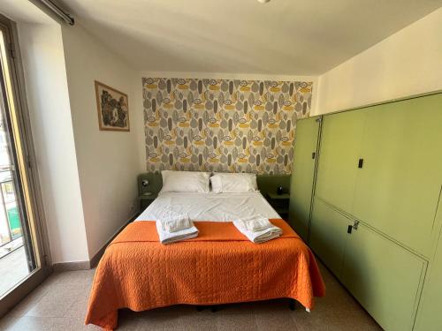 A bed or beds in a room at home.70 Carini