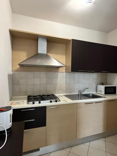 a kitchen with a sink and a stove at Casa Vacanze Celeste e C in Marzamemi