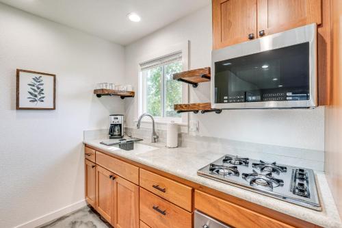 a kitchen with a sink and a stove at Welcoming Grants Pass Retreat - Walk to Park! in Grants Pass