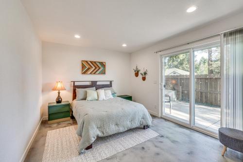 a bedroom with a bed and a large window at Welcoming Grants Pass Retreat - Walk to Park! in Grants Pass